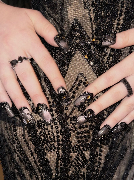 Chappell Roan's hands modeling a jewelencrusted cat eye manicure